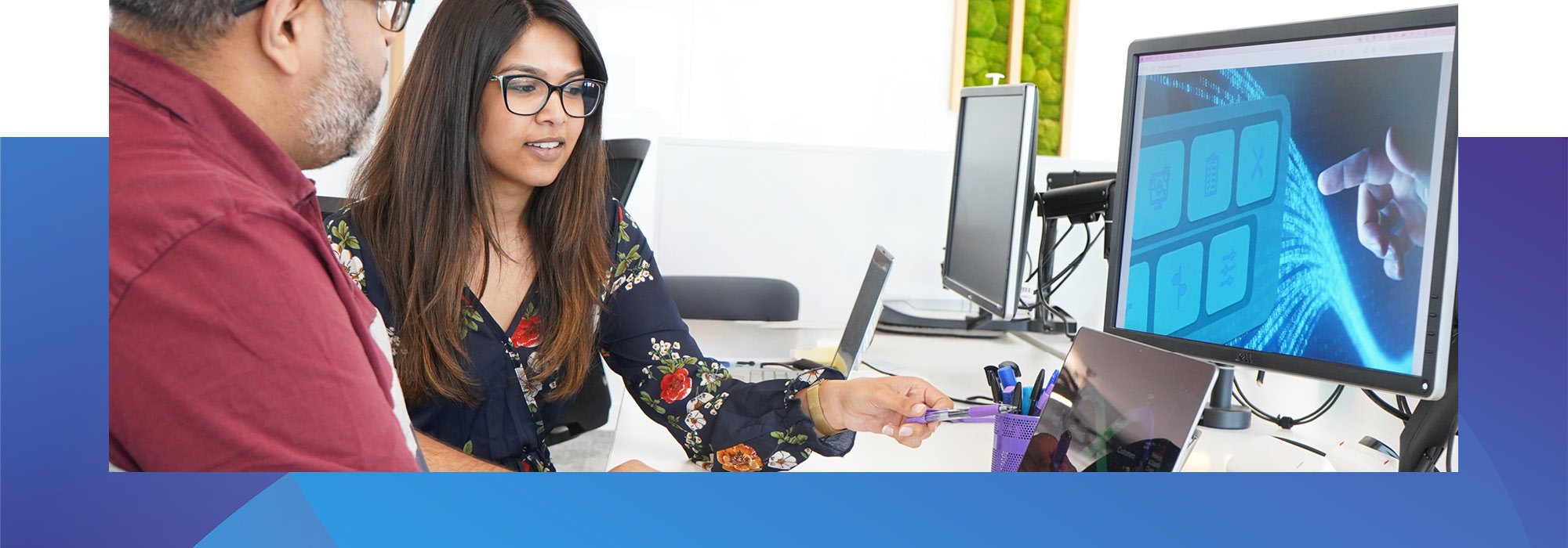 Decorative photo of Methods employees working on a desk in the Methods office