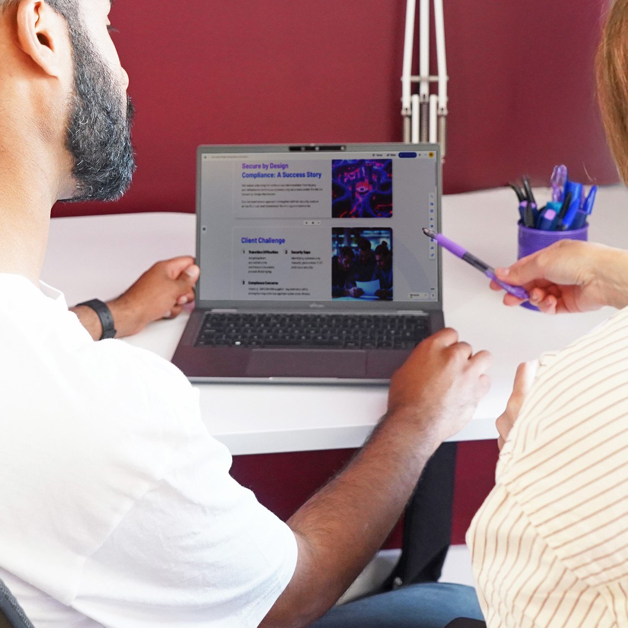 Decorative photo of Methods employees working together on a desk in the office