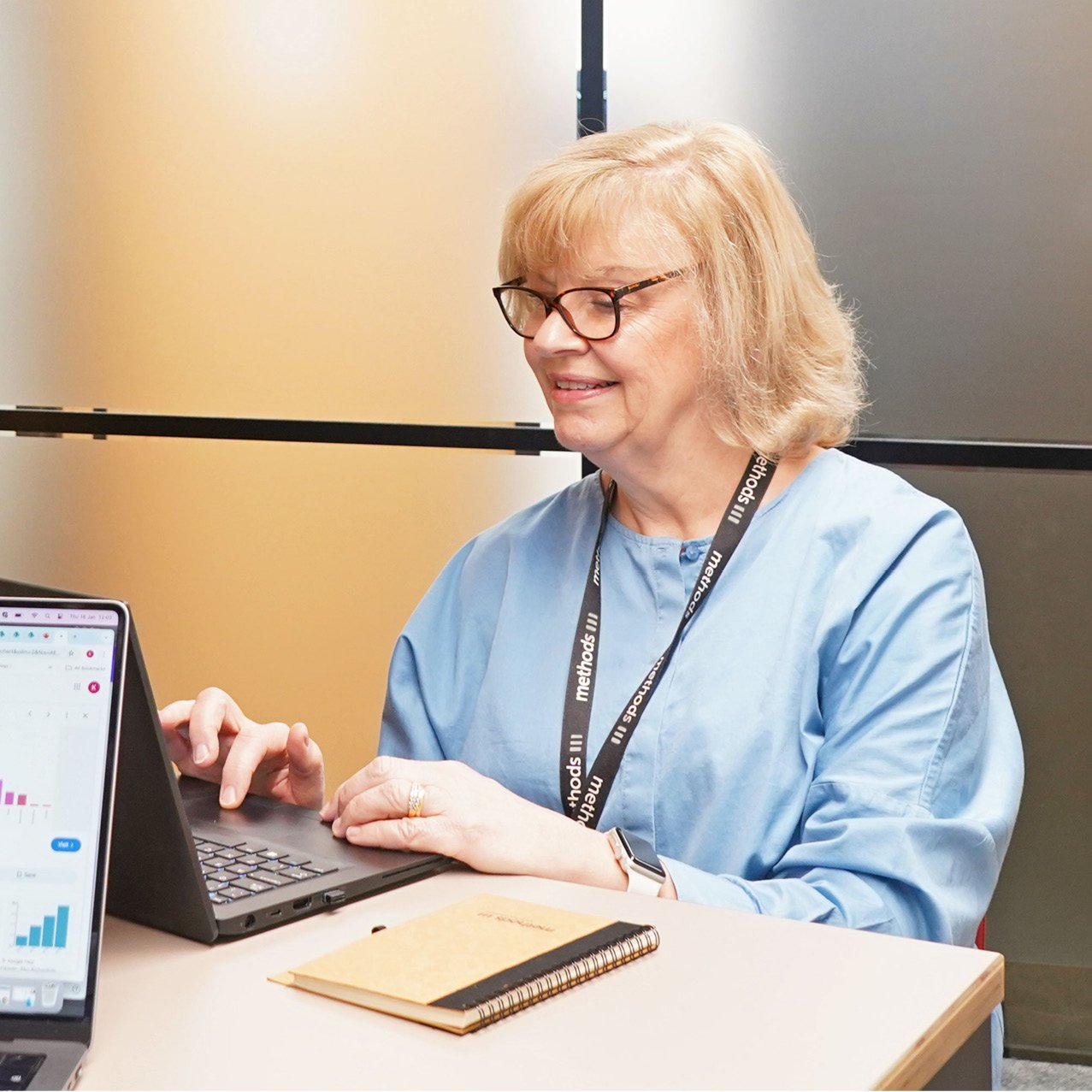 Decorative photo of a Methods employee typing on a laptop in the office