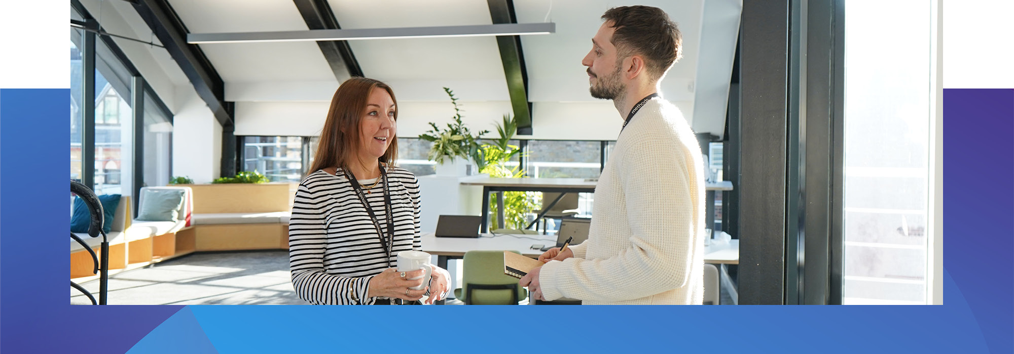 Decorative photo of Methods employees standing and talking in the Methods office