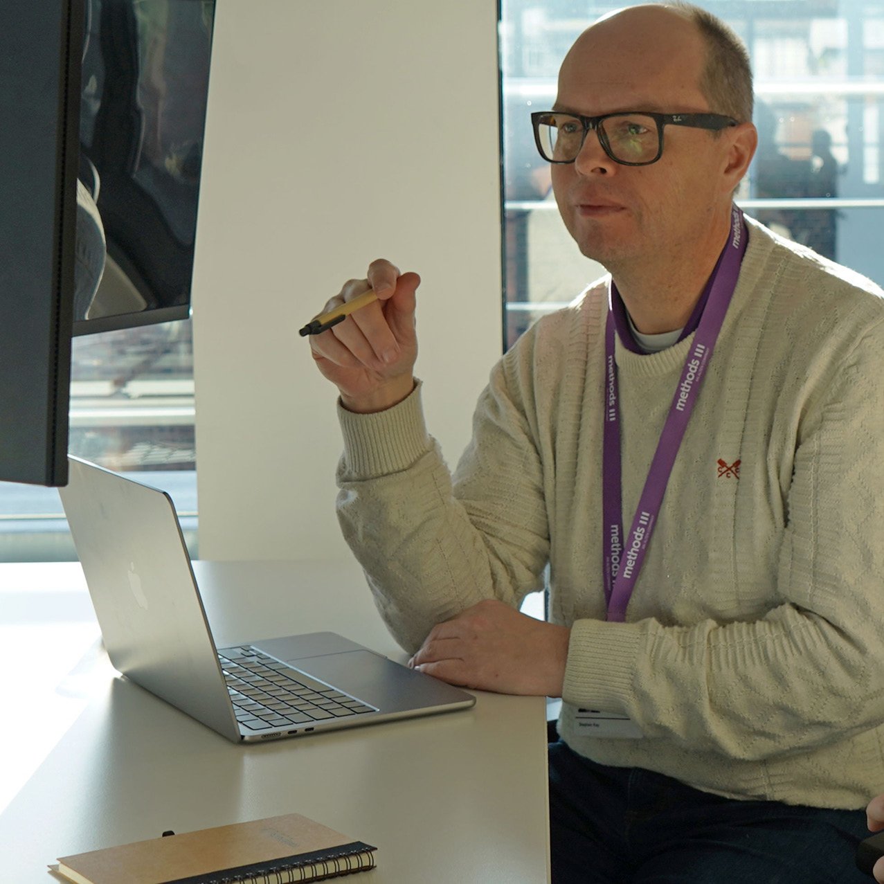 Decorative photo of a Methods employee working on a desk in the office