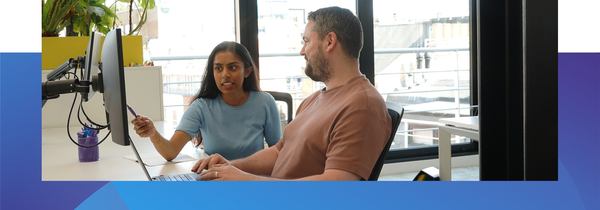 Decorative photo of Methods employees working on a desk in the Methods office