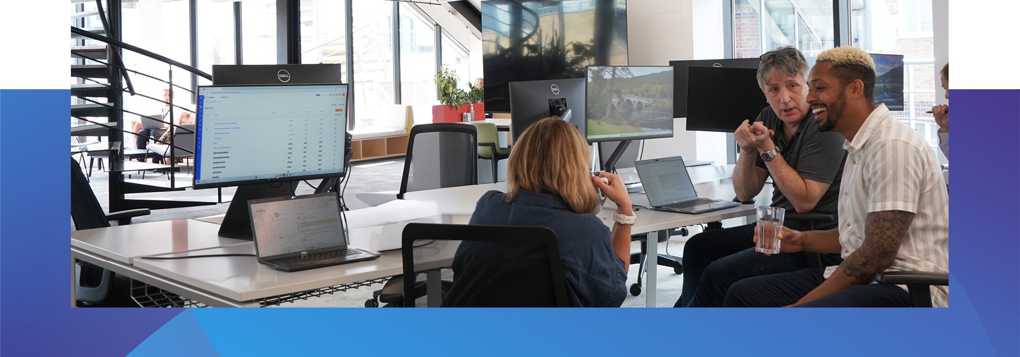 Decorative photo of Methods employees having a group meeting on a desk in the Methods office