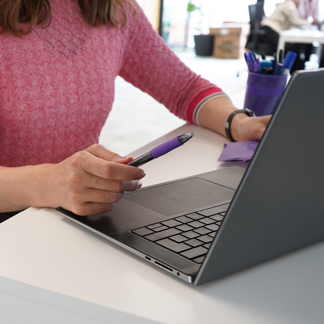 Decorative photo of a Methods employee working on a desk in the office